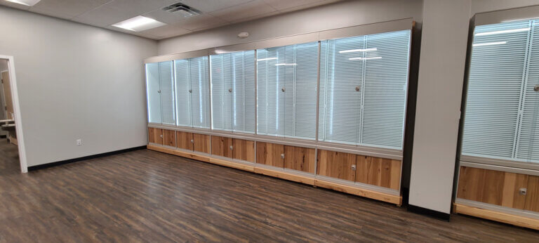 A business space with a lighted modular wall unit for storage and display