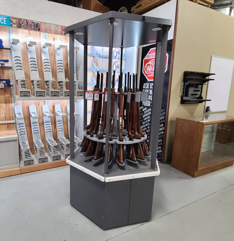 A display case showcasing various guns, including a prominent gun turret