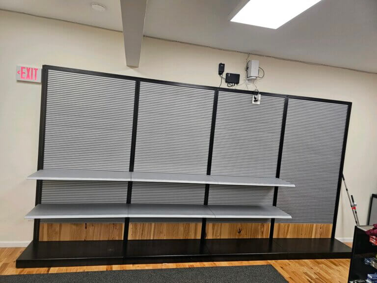 An empty modular wall unit with metal shelves