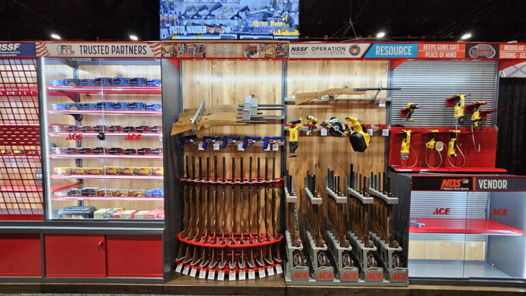 A display rack featuring various firearms in a retail store setting