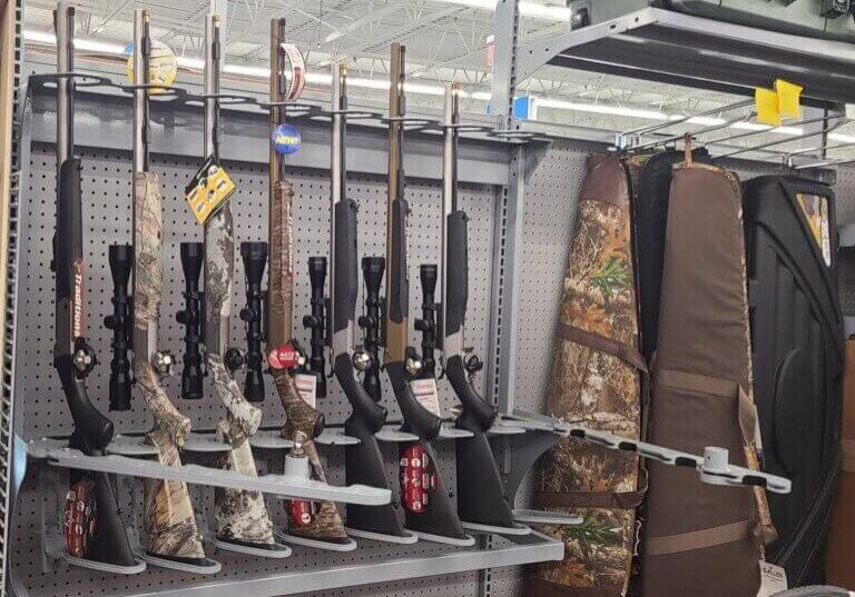 Locker A display rack featuring various firearms in a retail store setting