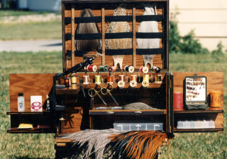 Anglers Armory Wooden furniture displaying pheasant feathers and thread